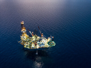 Aerial view from a drone of an offshore jack up rig at the offshore location during twilight time