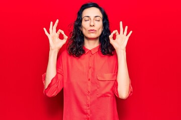 Young beautiful hispanic woman wearing casual clothes relax and smiling with eyes closed doing meditation gesture with fingers. yoga concept.