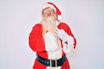 Old senior man with grey hair and long beard wearing santa claus costume smiling with hands on chest with closed eyes and grateful gesture on face. health concept.