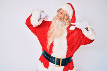 Old senior man with grey hair and long beard wearing santa claus costume with suspenders smiling cheerful showing and pointing with fingers teeth and mouth. dental health concept.