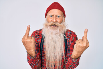Old senior man with grey hair and long beard wearing hipster look with wool cap showing middle finger doing fuck you bad expression, provocation and rude attitude. screaming excited