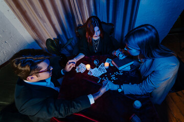 People hold hands of night at table with candles