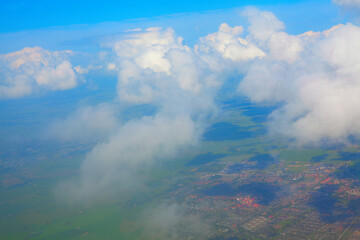 Flying over the clouds , aerial city view 