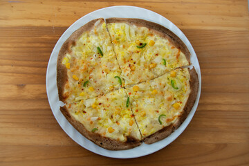 homemade peasant pizza with onion, corn and pepper