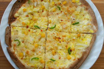 homemade peasant pizza with onion, corn and pepper