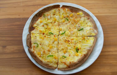 homemade peasant pizza with onion, corn and pepper