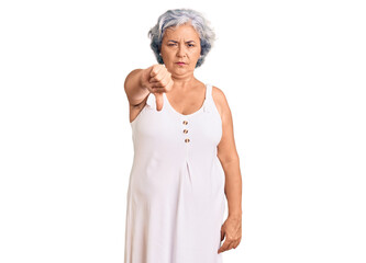 Senior woman with gray hair wearing casual clothes looking unhappy and angry showing rejection and negative with thumbs down gesture. bad expression.