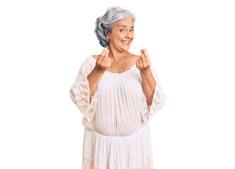 Senior woman with gray hair wearing bohemian style doing money gesture with hands, asking for salary payment, millionaire business