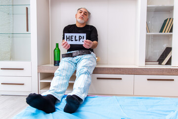 Old man drinking wine in the bedroom