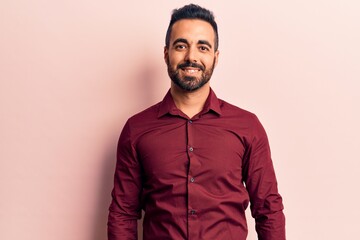 Young hispanic man wearing casual clothes with a happy and cool smile on face. lucky person.