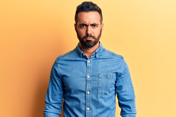Obraz premium Young hispanic man wearing casual clothes skeptic and nervous, frowning upset because of problem. negative person.