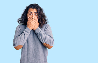 Young arab man wearing casual clothes shocked covering mouth with hands for mistake. secret concept.