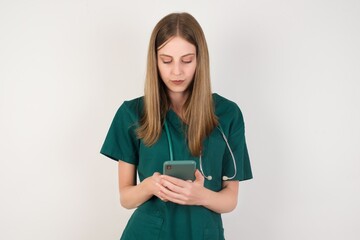 Portrait of excited Female doctor wearing a green scrubs and stethoscope  winking and eye hold...