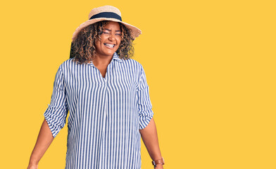 Young african american plus size woman wearing summer hat winking looking at the camera with sexy...