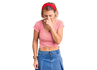 Young blonde woman wearing casual clothes and diadem feeling unwell and coughing as symptom for...