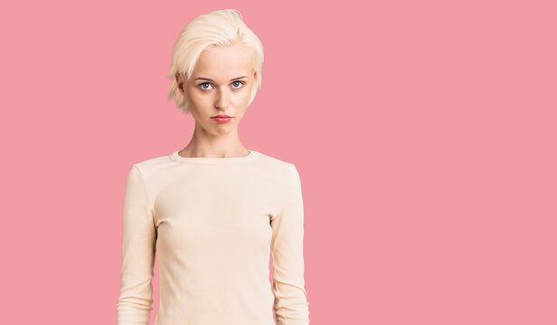 Young blonde woman wearing casual clothes looking sleepy and tired, exhausted for fatigue and hangover, lazy eyes in the morning.