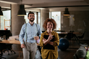 Businesswoman and businessman discussing work in office. Two friends in working together.