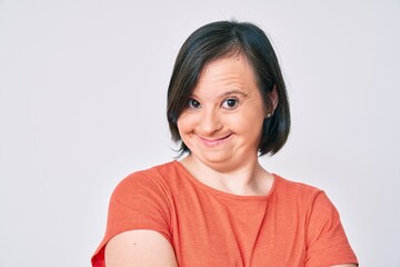 Brunette woman with down syndrome wearing casual clothes happy face smiling with crossed arms looking at the camera. positive person.