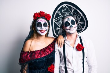 Couple wearing day of the dead costume over white with a happy and cool smile on face. lucky person.