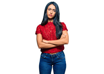 Beautiful hispanic woman wearing elegant shirt skeptic and nervous, disapproving expression on face with crossed arms. negative person.