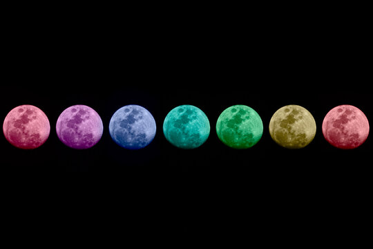 colorful moons in the dark sky, many moons in the sky, many colored moons in the dark sky, blue moon, red moon, yellow moon, green moon