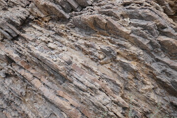 Layers of exposed geological sedimentary rock in cliff side