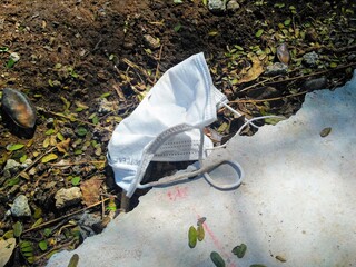 a protective mask discarded on the street
