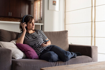 Fototapeta premium young woman talking on phone with headphones