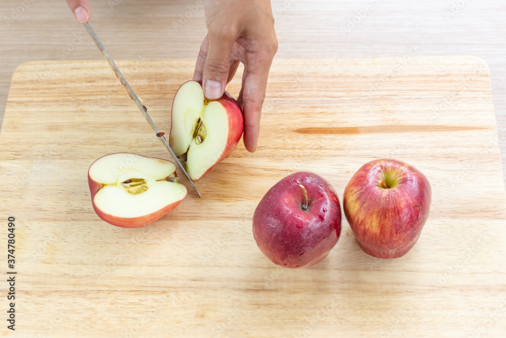 Wall mural Apples and slices on wooden cutting board.