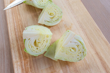 cabbage and cutted cabbage on wooden