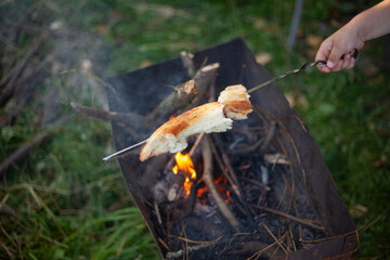 The bread is fried over a fire.