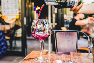 fancy elegant cafe restaurant red wine pouring waiter