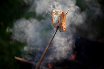 The bread is fried over a fire.