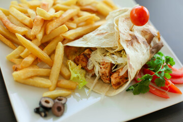 French fries and chicken pieces on a plate