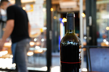 cafe restaurant blur bokeh background red wine bottle focus