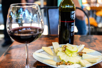 red wine glass bottle with fruit salad in a cafe restaurant