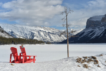 Winter day at Lake Minnewanka with orange chairs