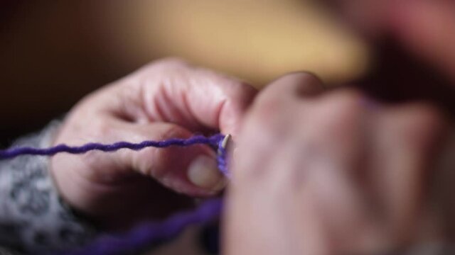 ederly woman hands Knitting doing crochet slow motion 4k