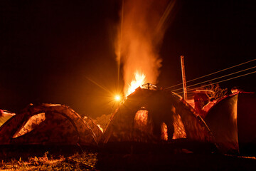 Mountain camping bonfire at night