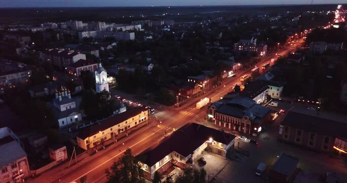 Scenic view from drone of Cathedral of Intercession of Holy Virgin with belfry and M7 Volga Highway with Pokrov twilight cityscape on background 