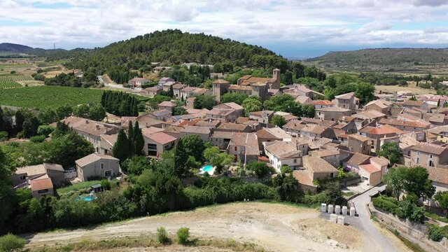 Scenic aerial view of French township of Fontcouverte at foot of Alaric mountain on sunny summer day, Aude, Occitanie