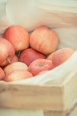 Fresh ripe apples in wooden box on stall at bazaar