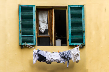 clothes drying in front of an old window © filiz