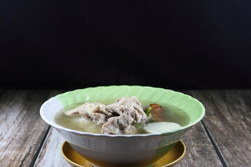 Traditional clear soup of cutting white radish and chopped pork rib in the bowl. Famous hot and freshness soup in Asia restaurant. 