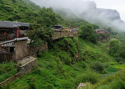 Ancient Xuankong (hanging in air) or Wanghuagou Village built between cliffs in Mount Guancen of Luya Mountains, Ningwu County, Xinzhou, Shanxi, China. Altitude of 2300 meters. Stilted wooden houses.