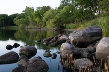 Fototapeta na wymiar Lake Herman shoreline, Rocks, trees, and reflection