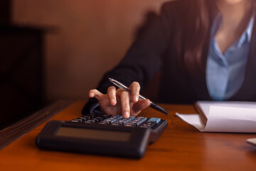 Fototapeta premium Business women working with calculator and business document on office table in office. finance accounting concept.