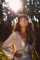 beautiful young cheerful woman with frangipani close up portrait at sunset