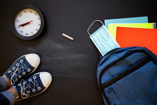 back to school concept during pandemic top view of sneakers backpack mask