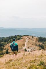 Obraz premium man with backpack hiking by autumn mountains